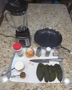 Fresh ingredients for Chicken Enchiladas with Poblano Cream Sauce from Scofield Fruits in Loveland, CO, featuring fire-roasted poblano chiles, a whole candy onion, purple garlic cloves, and Mexican crema.